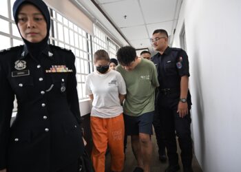 TEOH Wai Loon (dua dari kanan) dan Lim Suk Pei (tiga dari kanan) didakwa di Mahkamah Majistret Ipoh hari ini atas pertuduhan mengedar dadah jenis Methylenedioxymethamphetamine (MDMA) seberat 480.60 gram, minggu lalu.