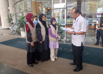 Siti Syakirah (tiga dari kiri) menyerahkan memorandum kepada Nasaruddin (kanan) di lobi KPM, hari ini.
