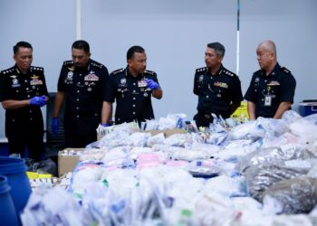MOHD. Yusoff Mamat (tiga kiri) memeriksa dadah yang akan dilupuskan semasa sidang media pelupusan barang kes melibatkan dadah di Ibu Pejabat Kontinjen (IPK) Kelantan di Kota Bharu, Kelantan hari ini-UTUSAN/KAMARUL BISMI KAMARUZAMAN.