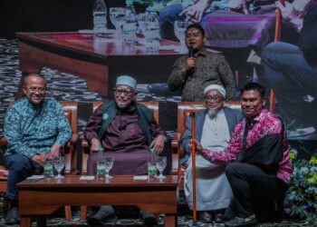 MUHAMAD Muqharabbin memegang tongkat yang diserahkan Abdul Hadi Awang selepas memenangi bidaan bernilai RM16,500 pada Majlis Makan Malam Amal Pas Melaka di sebuah hotel di Ayer Keroh, semalam. – FACEBOOK MUHAMAD MUQHARABBIN