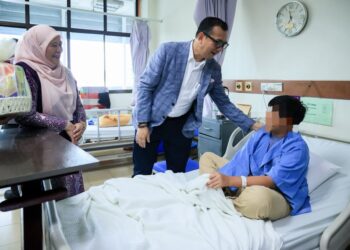 DR. Ab. Rahman Izani Ghani (dua kiri) semasa menyantuni seorang kanak-kanak yang mendapatkan rawatan di Hospital Pakar Universiti Sains Malaysia (HPUSM), Kota Bharu, Kelantan hari ini-UTUSAN/KAMARUL BISMI KAMARUZAMAN
