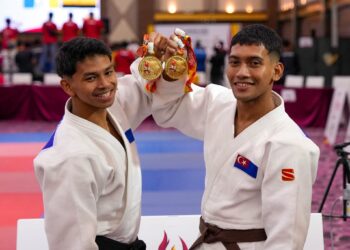 Atlet judo Johor, Muhammad Nur Amin Mohd Faizal (kiri) dan Putera Muhammad Qaid Muaz Mohd Zallei (kanan) bersama pingat emas yang dimenangi meraikan kemenangan dalam acara judo lelaki -55kg dan -60kg pada Sukan Malaysia (SUKMA) 2026 di IDCC hari ini. - IHSAN MEDIA DIGITAL JOHOR