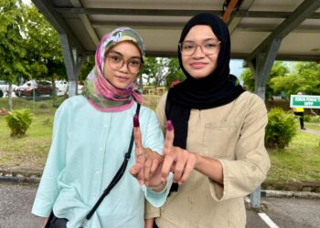 NUR Syuhada Ahmad Rosdi (kiri) dan adiknya, Nur Syakirah Ahmad Rosdi ketika ditemui di pusat mengundi di Institusi Pengajian Guru Raja Melewar, Sikamat, Seremban, hari ini. - UTUSAN/NOR SHAFIQAH MOHD GHAZALI