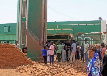 PENDUDUK berkumpul untuk membersihkan serpihan di kawasan kompleks sebuah masjid yang terkena serangan dron di kawasan El-Droshab, Khartoum Utara. - AFP