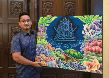 MUHAMAD Zulfadli Abdul Ghani bersama hasil karyanya yang dinobatkan sebagai Johan Kategori Karya Siap (Batik) pada Festival Kaligrafi Islam Terengganu Kali Kedua Peringkat Kebangsaan di Taman Tamadun Islam, Kuala Terengganu, Terengganu. – UTUSAN/PUQTRA HAIRRY