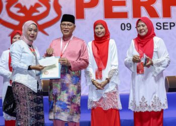 WAN Rosdy menyampaikan anugerah Anugerah Media Wanita UMNO Malaysia kepada Aslinda Nasir (kiri) di Perhimpunan Agung UMNO (PAU) 2026.