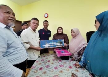 SAIFUDDIN Nasution Ismail, beramah mesra dengan Nurul Arini Abdullah, 19, pelajar cemerlang SPM di Kampung Bukit Tembok, Port Dickson, hari ini. - UTUSAN
