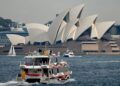 SEBUAH bot membawa pelancong di Sydney Harbour. - AFP