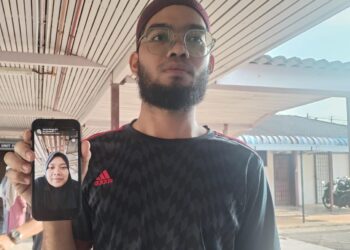 WAB Muhammad Naim Wan Hussin menunjukkan foto Rubayyi Razak ketika ditemui di Unit Forensik Hospital Besut, Terengganu. - UTUSAN /WAN ZURATIKAH IFFAH WAN ZULKIFLI