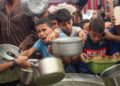 PENDUDUK Palestin berebut untuk mendapatkan hidangan yang diagihkan oleh dapur amal di kem pelarian Nuseirat, di tengah Gaza.- AFP