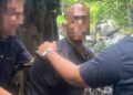 SUSPEK (tengah) semasa ditahan polis dalam serbuan di Pasir Puteh, Kelantan pagi tadi.