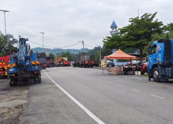 BARISAN kenderaan berat berbaris berdekatan sebuah gerai dan masjid di Jerantut Feri, Jerantut, Pahang untuk melakukan pemeriksaan kenderaan di bawah Jambatan Sungai Pahang.