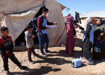 SUKARELAWAN memberi vaksin oral kepada seorang kanak-kanak di kem pelarian Maram di Idlib, barat laut Syria. - AFP 
