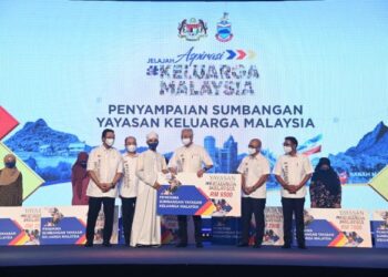 ISMAIL Sabri Yaakob (tiga kanan) menyampaikan sumbangan Yayasan Keluarga Malaysia kepada salah seorang penerima semasa perasmian Jelajah Aspirasi Keluarga Malaysia di Kota Kinabalu hari ini.