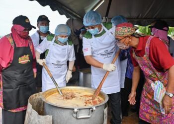 NANCY Shukri (dua, dari kiri) memasak gulai kawah di samping Menteri Besar, Datuk Seri Dr. Ahmad Samsuri Mokhtar (dua, kiri ) dalam Program Rewang Raya sempena Majlis Rumah Terbuka Aidilfitri Malaysia 2022 di Masjid Seberang Takir di Kuala Nerus hari ini. -PUQTRA HAIRRY ROSLI