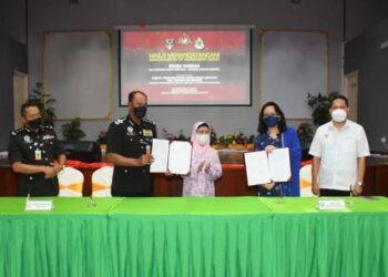 NORDIN Muhamad (dua dari kiri) bertukar dokumen MoA dengan Dr Sabariah Putit (dua dari kanan) dengan disaksikan oleh Juma’ani Tun Tuanku Bujang di Kuching hari ini.