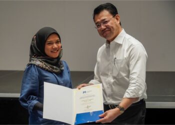 NOR Azam M. Taib menyampaikan sijil program keusahawan GRAP kepada Rahayu Mohamed di Petaling Jaya, semalam. – UTUSAN/AMIR KHALID