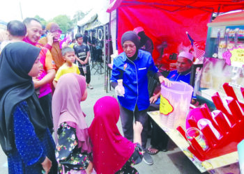 WAN Roslina Wan Abdul Manan dan Zanah Ismail berniaga aiskrim di Bandar Kuala Berang, Hulu Terengganu. – UTUSAN/NOOR HAYATI MAMAT