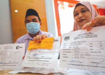 AZLIYATI Zainol bersama suami, Baharudin Bakar menunjukkan borang kemasukan ke wad HSB yang diterima setelah pembedahan tertangguh sebanyak tiga kali.