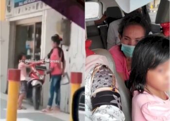 SURYANI (baju merah jambu) ditahan polis selepas videonya memukul cucunya di khalayak ramai tular dalam media sosial. - AGENSI