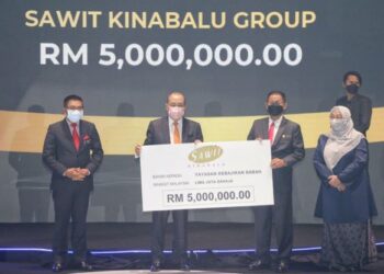 HAJIJI Noor (dua kiri) menerima sumbangan daripada Pengarah Urusan Kumpulan Sawit Kinabalu Bacho Jansie (tiga kiri) sempena Majlis Setahun Kerajaan GRS bersama rakyat di Kota Kinabalu hari ini