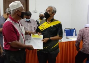 DR. MOHD. Hatta Md. Ramli (kanan) menyerahkan sumbangan kepada wakil jawatankuasa masjid, surau dan NGO pada Majlis Penyerahan Cek Sumbangan Ramadan Parlimen Lumut di Seri Manjung hari ini. - UTUSAN/SHAMSUL KAMAL AMARUDIN