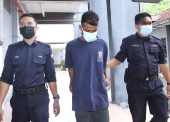 M. Krishnaa Kumar (tengah) dihadapkan ke Mahkamah Majistret Ipoh hari ini atas pertuduhan membunuh seorang wanita yang mayatnya dijumpai dalam kawasan semak di Tambun, Ipoh minggu lalu. - UTUSAN/MUHAMAD NAZREEN SYAH MUSTHAFA