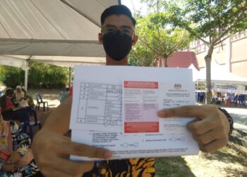 AHMAD AS-SYAHEED Ahmad Misbah menunjukkan kad vaksinasi Covid-19 selepas menerima suntikan dos pertama di PPV Dewan Tun Ali, Bukit Katil, Melaka. - UTUSAN MUHAMMAD SHAHIZAM TAZALI