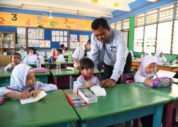 AZHAR Darus (berdiri) beramah mesra bersama murid-murid tahun satu Bestari sempena hari pertama sesi akademik 2023/2024 di SK Sena, Kangar, Perlis hari ini.- UTUSAN/IZLIZAN OTHMAN