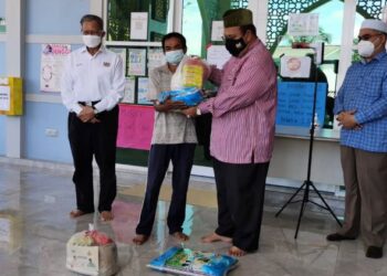ABDULLAH Ya’kub menyampaikan bakul makanan kepada penerima di Masjid Kampung Berdang, Jeli, hari ini. - FOTO/ROSALWANI CHE SOH