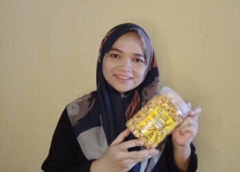 SITI Nordiana Sulaiman
menunjukkan Dianz
Popia Simpul dan
Dianz Popcorn
Caramel yang
dihasilkannya.