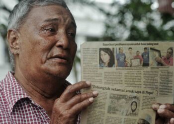 JAMALUDDIN Malek menunjukkan keratan akhbar mengenai Marina yang kini menjalani hukuman penjara di Nepal atas kesalahan mengedar dadah. – UTUSAN/MOHD. SHAHJEHAN MAAMIN