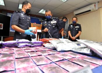 AYOB Khan Mydin Pitchay (tengah) melihat pelbagai jenis dadah yang berjaya dirampas dalam serbuan minggu lalu pada sidang akhbar di IPK Johor, Johor Bahru. - FOTO/RAJA JAAFAR ALI