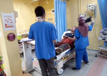 MUHAMMAD Ridzuan Kamaruzaman yang cedera selepas terjatuh ketika memadam kebakaran sebuah kilang besi menerima rawatan di Hospital Kemaman, Terengganu malam tadi. - UTUSAN/NIK NUR IZZATUL HAZWANI NIK ADNAN