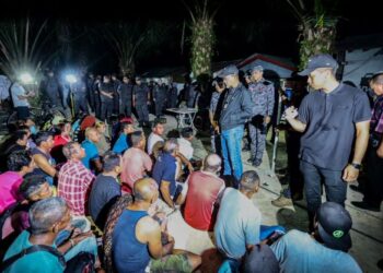 Khairul Dzaimee Daud (berdiri, dua dari kanan) bertanya sesuatu kepada warga asing yang ditahan dalam Operasi Penguatkuasaan Imigresen di kawasan ladang kelapa sawit Taman Perindustrian Air Hitam, Sijangkang, Selangor awal pagi semalam. MINGGUAN/AFIQ RAZALI
