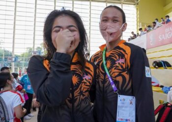 NUR Dhabitah Sabri (kiri) dan Pandelela Rinong terharu selepas memenangi pingat emas 10 meter platform seirama di Pusat Akustik My Dinh, Hanoi hari ini. - UTUSAN/SHIDDIEQIIN ZON