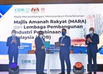 AHMAD Asri Abdul Hamid dan Azhar Abdul Manaf bertukar dokumen sambil disaksikan oleh Fadillah Yusof
dan Mahdzir Khalid (kanan) di Kuala Lumpur, semalam. – GAMBAR/CIDB