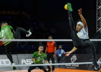 APIT kanan Putrajaya Cyborg, Mohamad Muslim M. Ramli (kanan) melakukan libasan ketika menentang Kelantan Warriors pada kejohanan Emas Anuar Liga Sepak Takraw (STL) 2021/22 di Stadium Titiwangsa, Kuala Lumpur hari ini. - UTUSAN/FARIZ RUSADIO