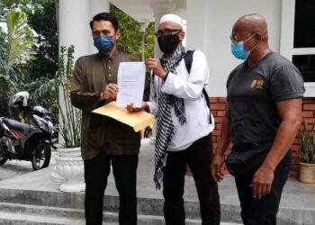 ROSLEI Kamisan (tengah) menyerahkan memorandum kepada wakil Istana Hinggap di Seremban hari ini.