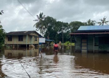 ANGGOTA bomba melakukan pemantauan keadaan banjir di Sungai Rengit, Pengerang, Kota Tinggi.