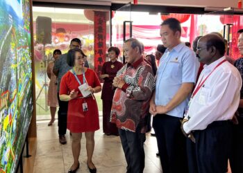 AMINUDDIN Harun mendengar taklimat pembangunan oleh pihak pemaju perumahan ketika hadir pada Majlis Rumah Terbuka Tahun Baharu Cina Bersama Sunrise MCL Land di Forest Height, Senawang, Seremban hari ini.-UTUSAN/ZAKKINA WATI AHMAD TARMIZI.