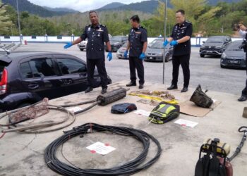 SHAMSUDIN Mamat (kiri) menunjukkan antara barangan yang dirampas termasuk kereta Perodua Myvi dalam Op Pintu ketika sidang akhbar di IPD Baling. -UTUSAN/NORLIA RAMLI