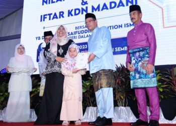 SAIFUDDIN Nasution Ismail menyerahkan surat keputusan permohonan kewarganegaran kepada penerimanya pada Majlis Penerapan Nilai-Nilai Murni dan Iftar KDN Madani di pekarangan IPK Negeri Sembilan di Seremba hari ini.-UTUSAN/MOHD. SHAHJEHAN MAAMIN.