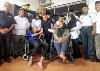 ADLY Zahari (tengah) mengunjungi veteran tentera, Zakaria Manaf (tiga dari kiri) dan isterinya, Asiah Baharom yang mengalami masalah kesihatan dan hanya berkerusi roda di Taman Desa Rhu, Sikamat, Seremban hari ini.-UTUSAN/MOHD. SHAHJEHAN MAAMIN.