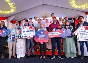 NGA Kor Ming (baris belakang, tiga dari kiri) dan Siew Fook (baris belakang, empat dari kiri) bersama para pembeli Residensi Seremban Sentral pada Majlis Penyerahan Kunci Residensi Seremban Sentral di Seremban hari ini.-UTUSAN/MOHD. SHAHJEHAN MAAMIN.