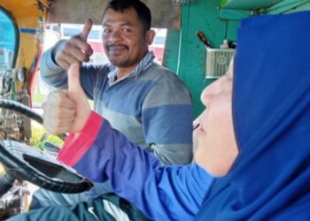 PEMANDU lori balak yang tidak mahu namanya disiarkan menumpangkan Noraini Hussin dan Noor Anis Najiha menyeberangi jalan raya yang digenangi banjir di Bandar Segamat, Johor.