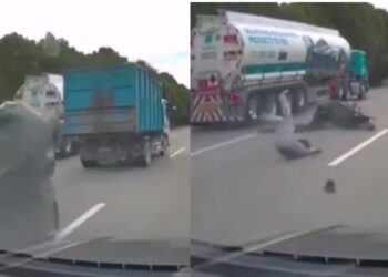 TANGKAP layar penunggang motosikal terjatuh selepas kain kanvas terbang dari sebuah lori dan membalutinya di Jalan Cyberjaya baru-baru ini.