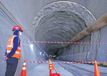 SEORANG pekerja melihat Terowong Genting Projek Laluan Rel Pantai Timur (ECRL) yang sedang dalam pembinaan di Bentong, Pahang.  – UTUSAN/FAUZI BAHARUDIN