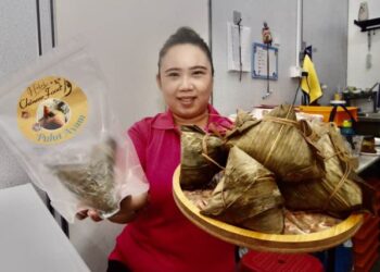 SOFIAH Mohd. Yusof menunjukkan kuih tradisional masyarakat Cina iaitu chang halal yang dihasilkannya yang mendapat permintaan tinggi dalam kalangan penggemar Muslim makanan itu di kedainya di Bayan Baru, Pulau Pinang.