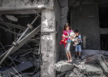 KANAK-KANAK Palestin mengambil barang mainan mereka dari rumah di Menara Al-Jawhara selepas musnah dalam serangan udara Israel di Gaza. - AFP